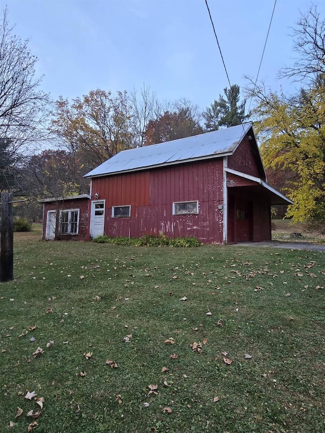 view of outbuilding featuring a lawn