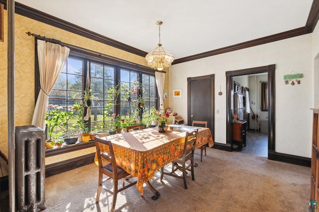 dining room featuring crown molding, a chandelier, and carpet flooring