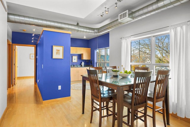 dining space with light hardwood / wood-style flooring