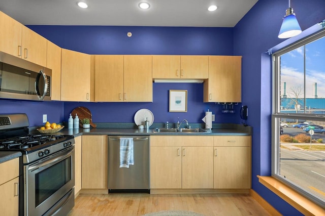 kitchen with light hardwood / wood-style flooring, light brown cabinets, stainless steel appliances, and sink