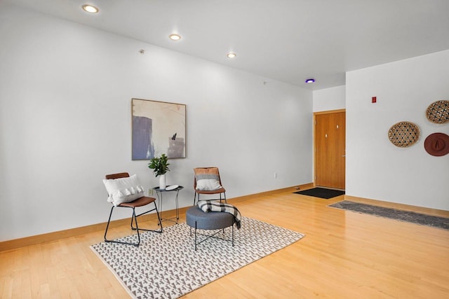 living area with hardwood / wood-style flooring