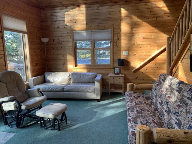 living area with wooden walls and carpet flooring