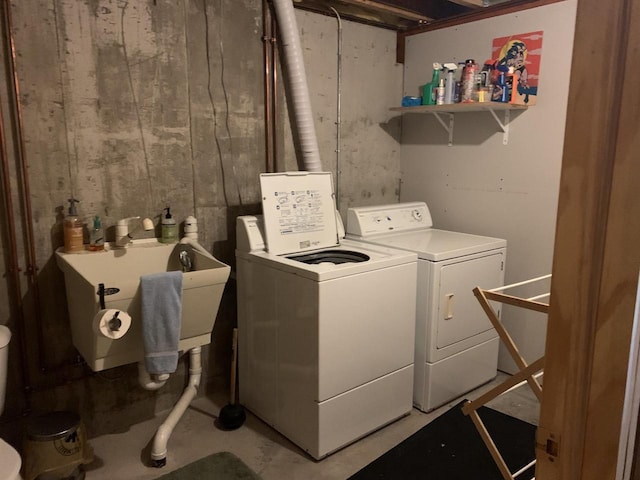 laundry area with washing machine and dryer and sink