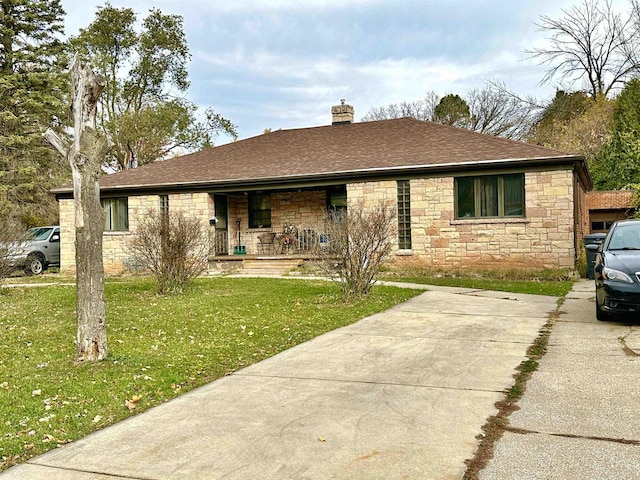 ranch-style house featuring a porch and a front yard