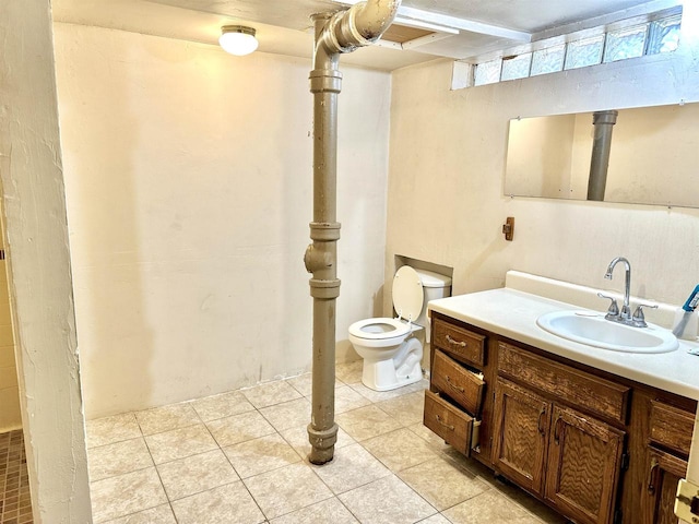 bathroom with vanity, toilet, and tile patterned floors