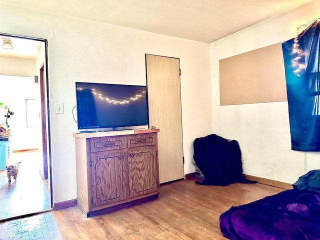 living room with baseboards and light wood-style flooring