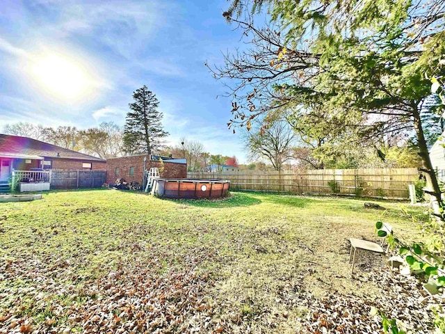 view of yard with a fenced in pool