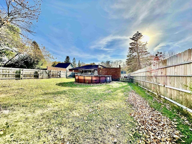 view of yard with a fenced in pool