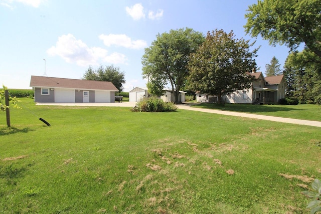 view of yard featuring an outbuilding and a garage