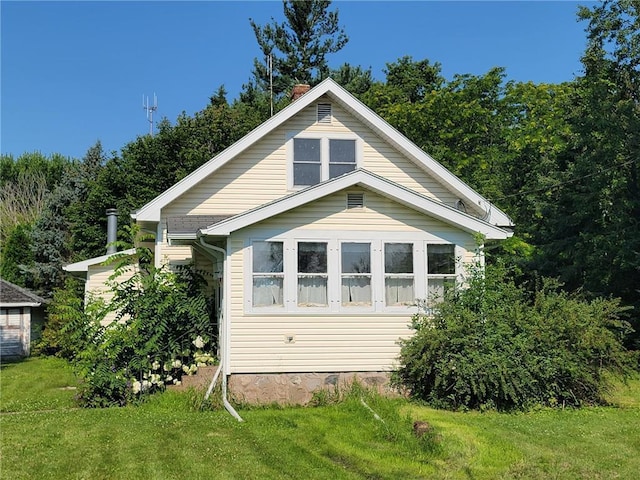 view of home's exterior featuring a yard