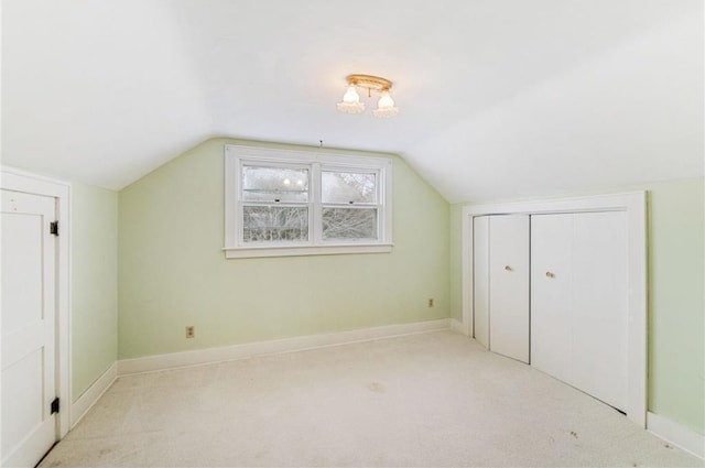 bonus room featuring light carpet and vaulted ceiling