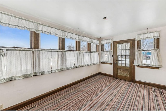 unfurnished sunroom with a wealth of natural light