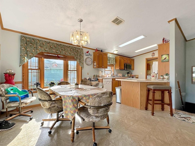 dining room featuring crown molding, a textured ceiling, lofted ceiling, and a chandelier