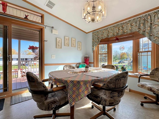 dining space with ornamental molding, a chandelier, and vaulted ceiling