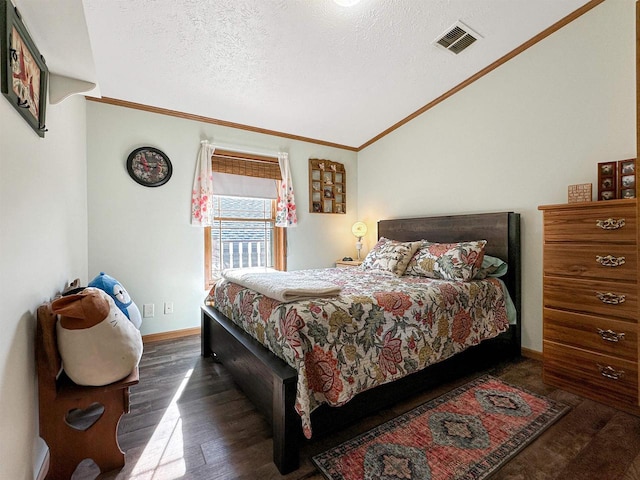 bedroom with ornamental molding, vaulted ceiling, a textured ceiling, and dark hardwood / wood-style flooring