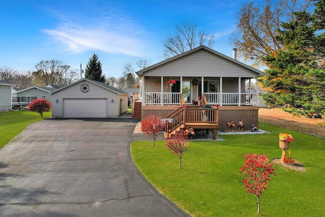 view of front of home with an outdoor structure, covered porch, a garage, and a front lawn