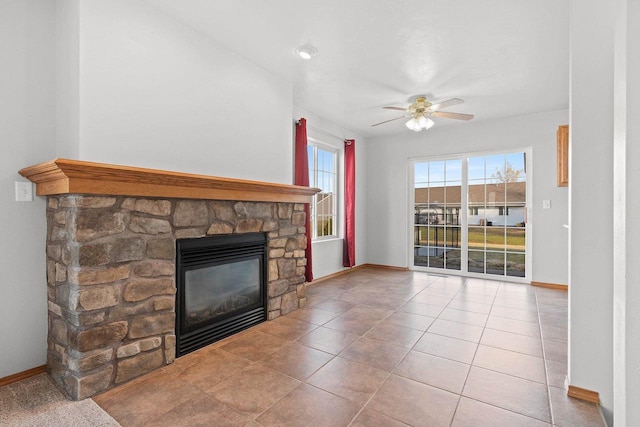 unfurnished living room featuring ceiling fan, tile patterned flooring, and a fireplace