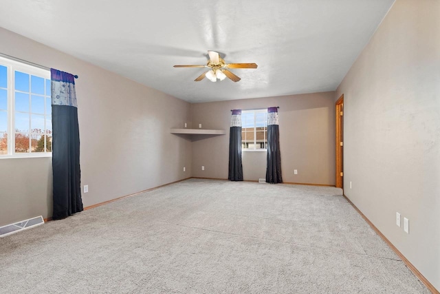 unfurnished room featuring light colored carpet and ceiling fan