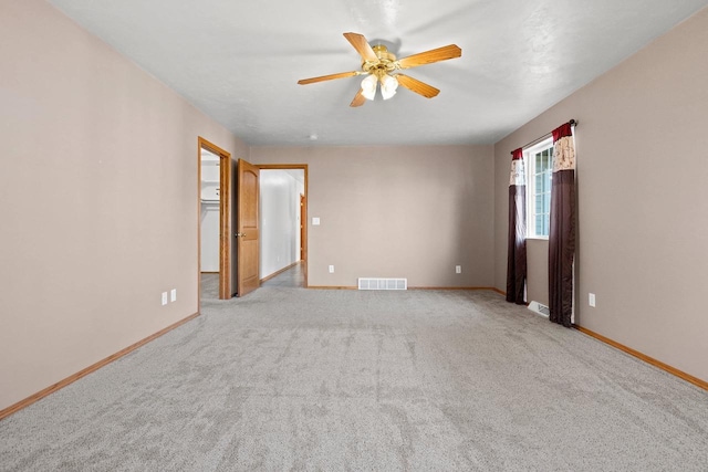 unfurnished room featuring light carpet and ceiling fan