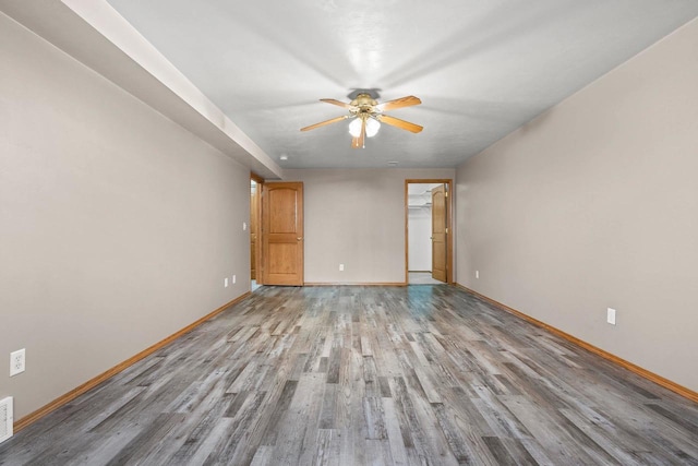 spare room with light wood-type flooring and ceiling fan