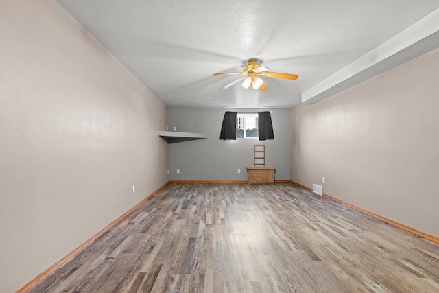 spare room with ceiling fan and hardwood / wood-style flooring