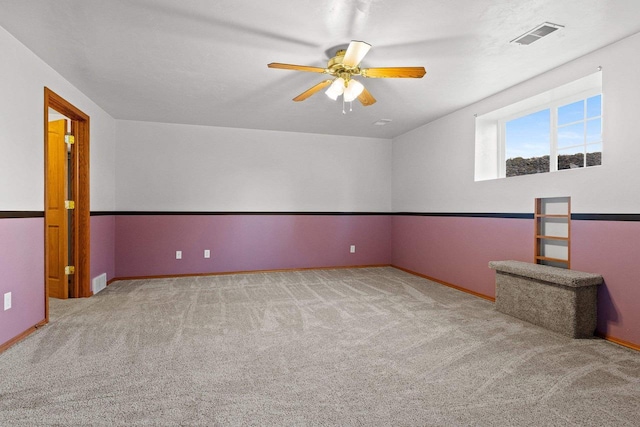 unfurnished room with light carpet, vaulted ceiling, and ceiling fan