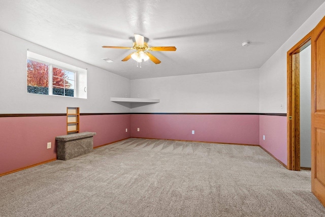 interior space featuring lofted ceiling, light colored carpet, and ceiling fan