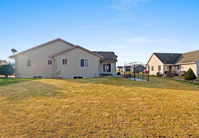 rear view of house with a gazebo and a lawn