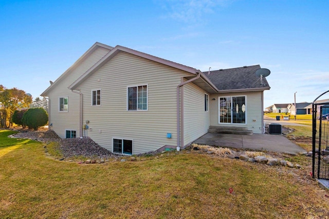 back of house featuring a patio, a lawn, and central AC unit