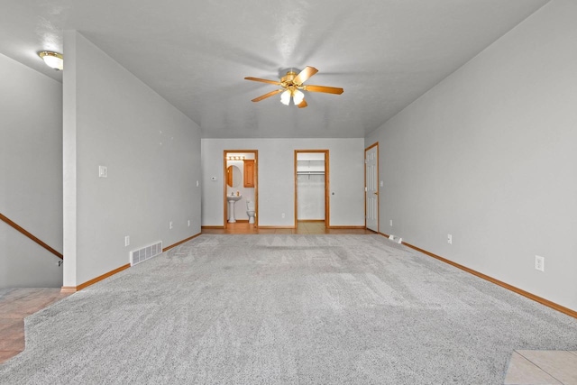 unfurnished room featuring ceiling fan and light colored carpet