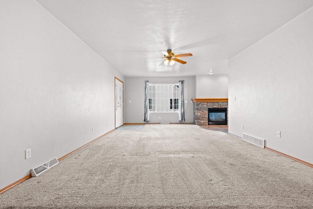 unfurnished living room featuring carpet floors, a fireplace, and ceiling fan