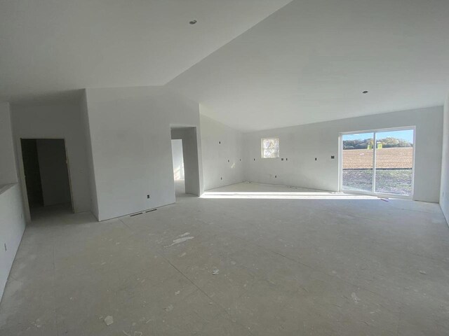 unfurnished living room featuring lofted ceiling