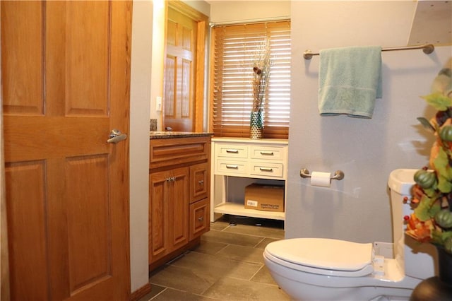 bathroom featuring vanity, toilet, and tile patterned flooring