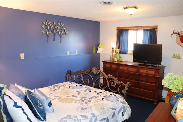 carpeted bedroom featuring a textured ceiling