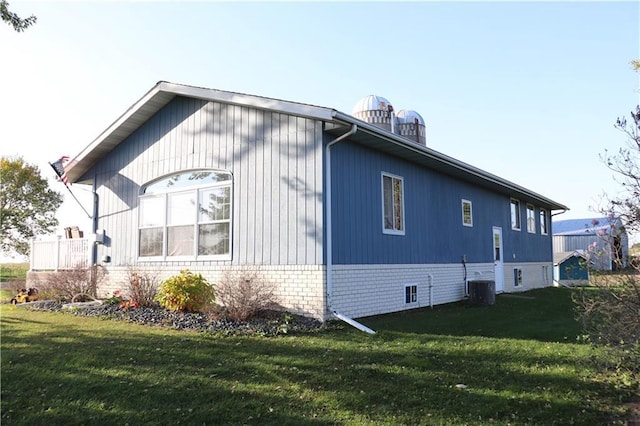 view of property exterior featuring a yard and central air condition unit