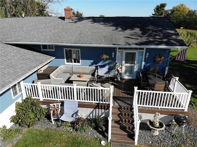 rear view of property featuring a wooden deck