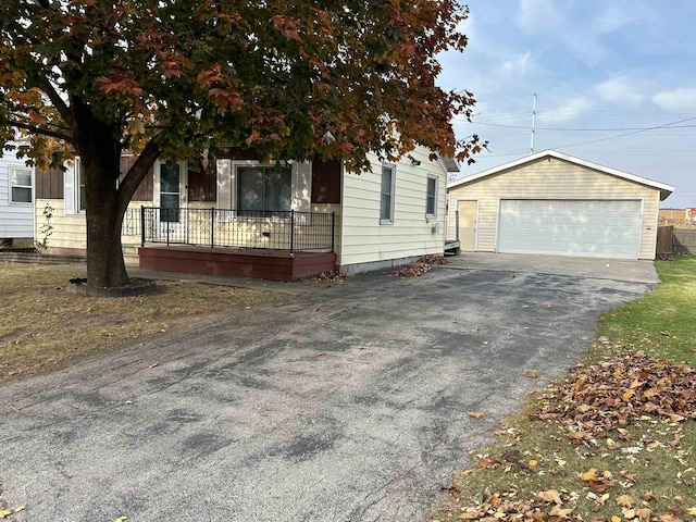 obstructed view of property featuring a porch, an outdoor structure, and a garage