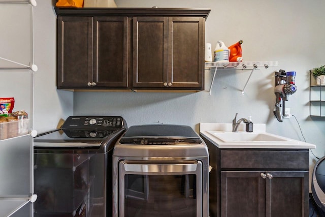 clothes washing area with sink, independent washer and dryer, and cabinets