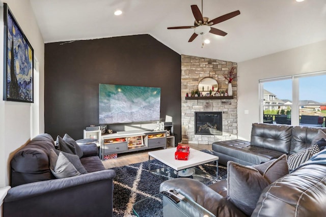 living room with lofted ceiling, hardwood / wood-style floors, a fireplace, and ceiling fan