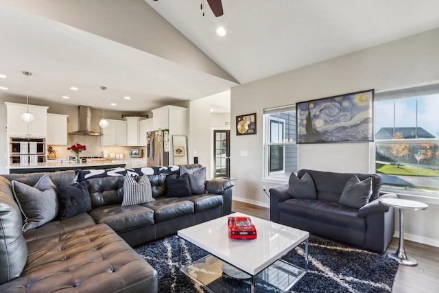 living room with lofted ceiling, wood-type flooring, and ceiling fan