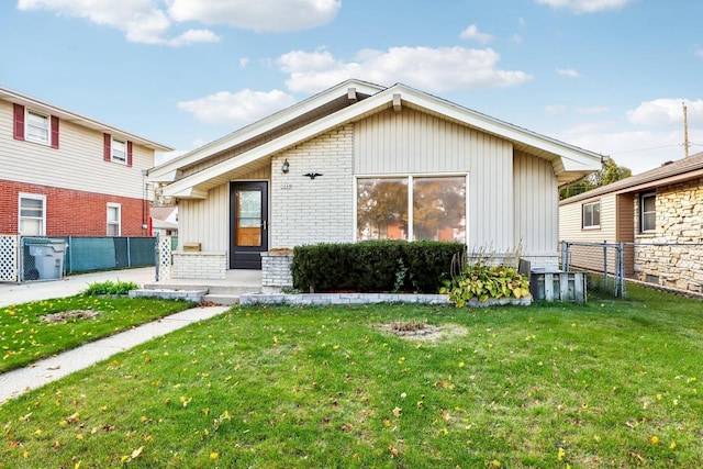 rear view of property with a yard