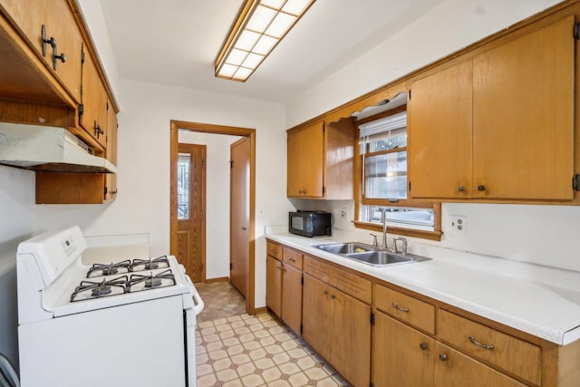 kitchen with sink and white gas stove