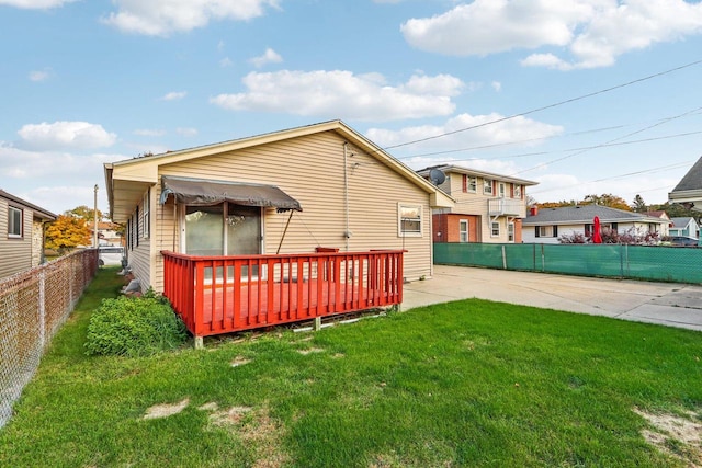 rear view of property featuring a lawn