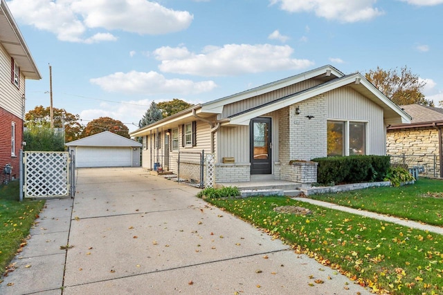 view of front facade with a garage, a front lawn, and an outbuilding