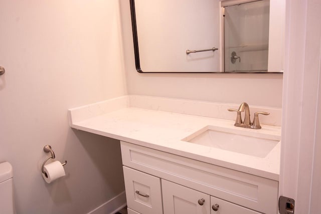 bathroom featuring toilet and vanity