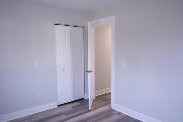 unfurnished bedroom with light hardwood / wood-style floors and a closet