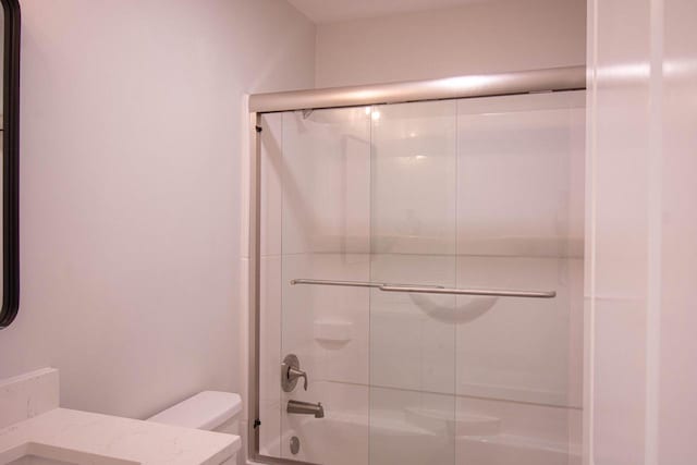 full bathroom with toilet, combined bath / shower with glass door, and vanity