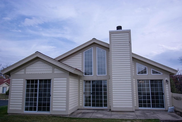 1642 Cottage Dr Unit 7-48, Lake Geneva, WI 53147 - back of house featuring fence and a chimney