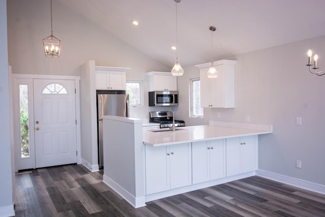 1642 Cottage Dr Unit 7-48, Lake Geneva, WI 53147 - kitchen with appliances with stainless steel finishes, an inviting chandelier, light countertops, a peninsula, and white cabinetry