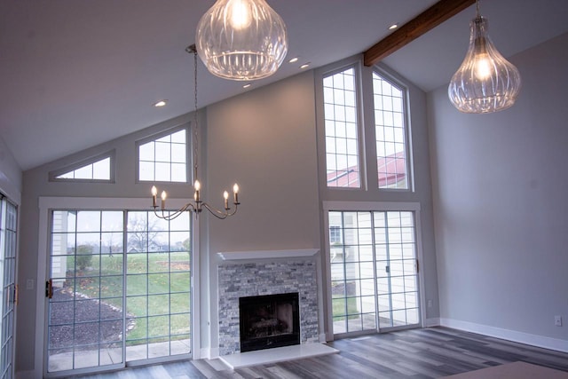 unfurnished living room with hardwood / wood-style flooring, beamed ceiling, high vaulted ceiling, and a fireplace